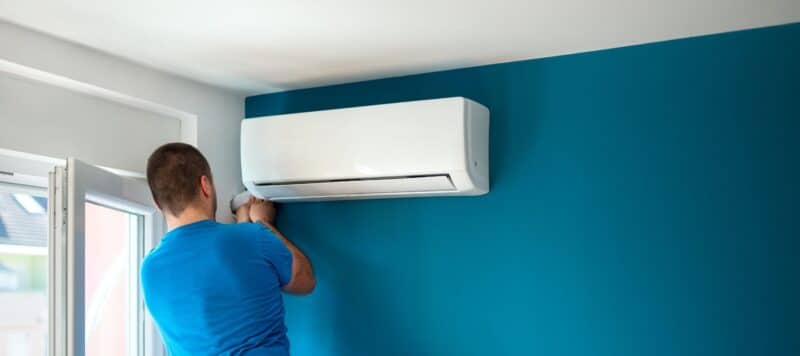 HVAC technician installing a ductless ac unit