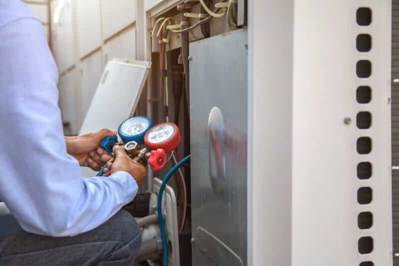 technician tuning up a heater